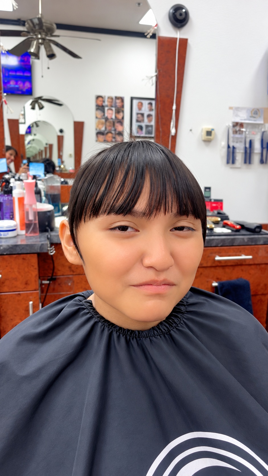 Women's haircut with straight bangs at Zara Hair Salon in Phoenix