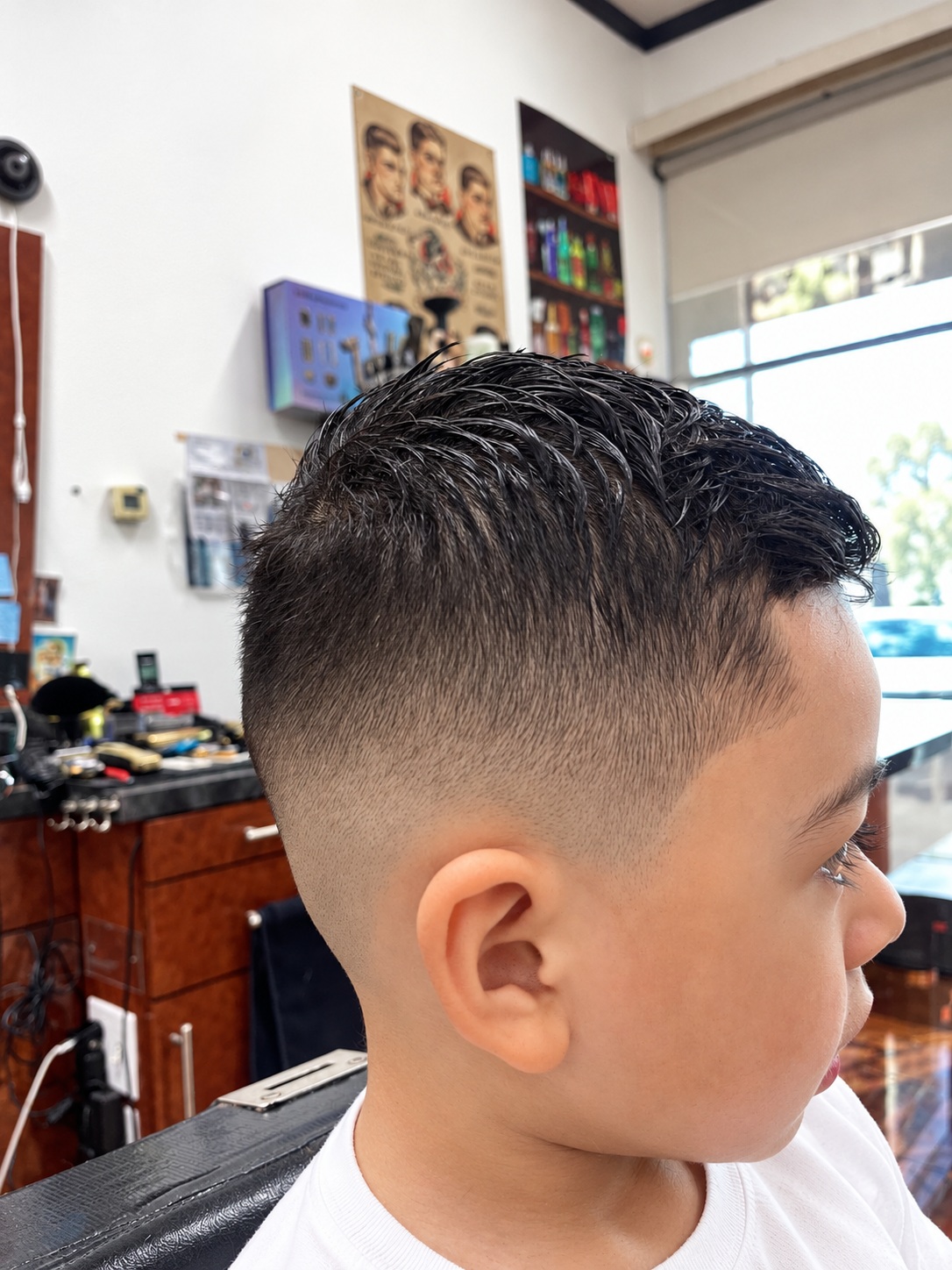 Boy's skin fade haircut in profile at Zara Barbershop