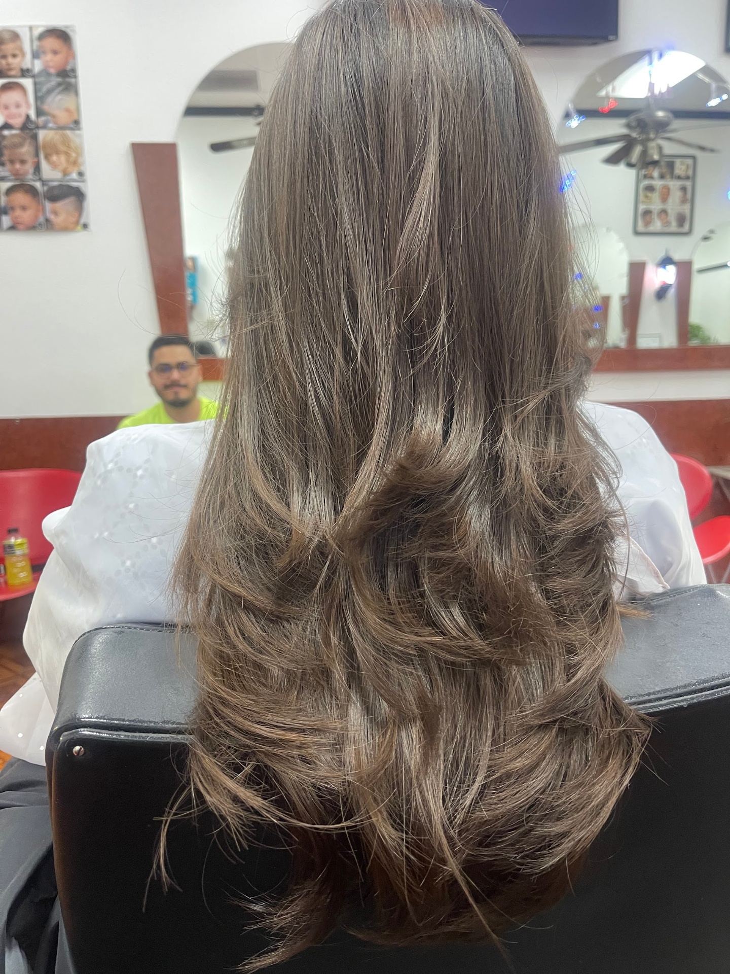 Long layered women's haircut with soft flowing ends