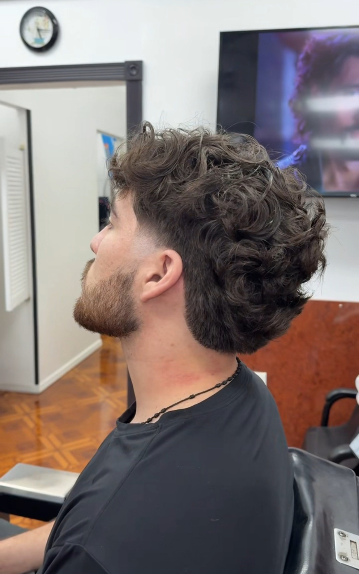 Men's curly mullet with low taper fade