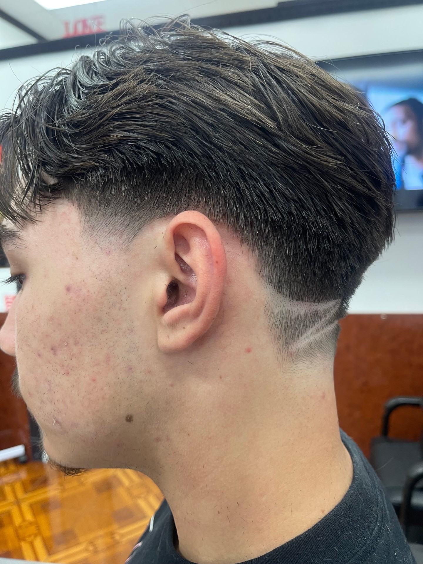Modern flow haircut with low taper and line detail