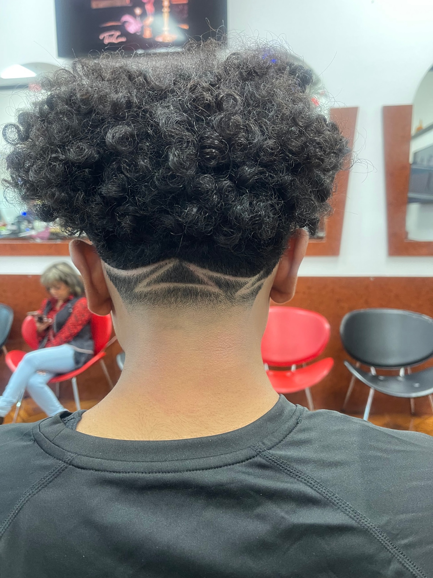 Curly top with custom star hair design and skin fade