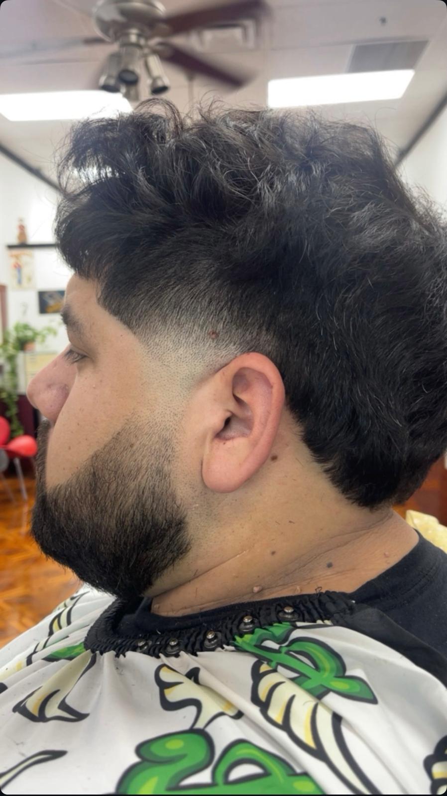 Men's mid drop fade with textured curly top and beard
