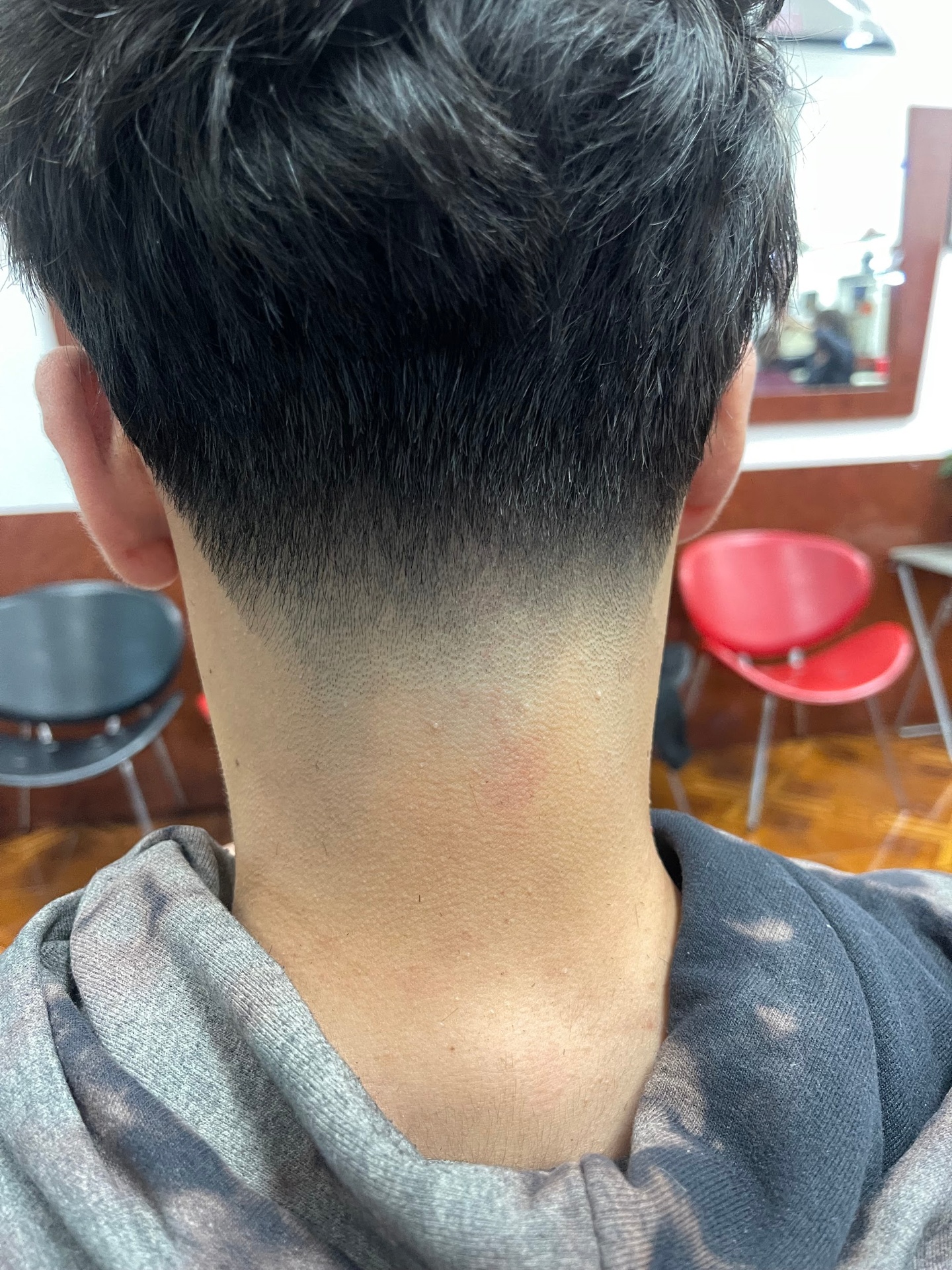 Clean nape shape-up with mid taper fade