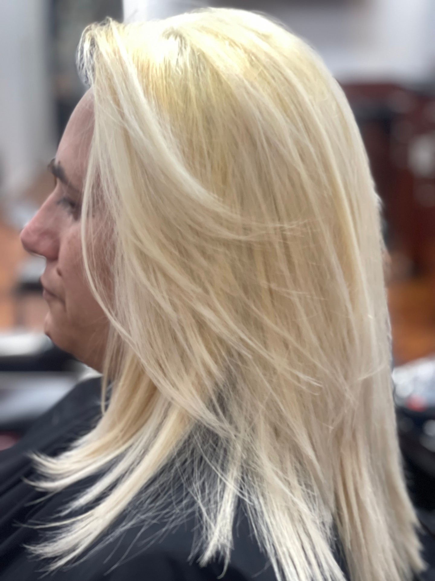 Platinum blonde color with layered women's cut